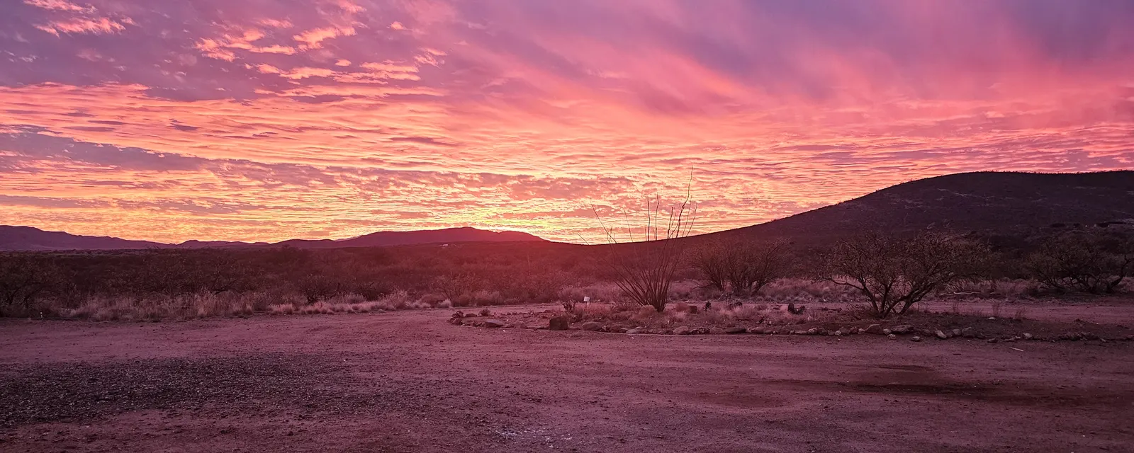 Pink and purple sunset sky over desert hills near Tombstone, Arizona