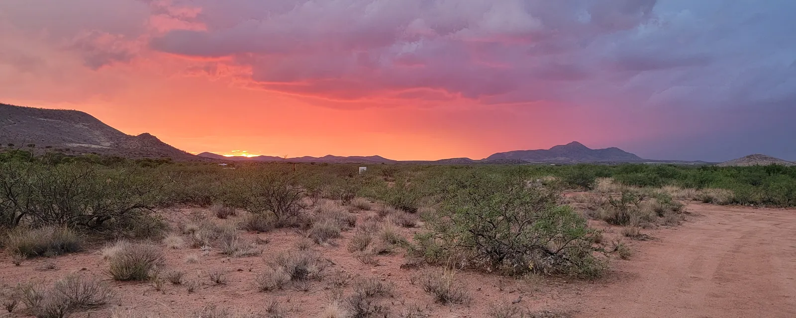 Pink sunset over a desert track and mountains in southeastern Arizona