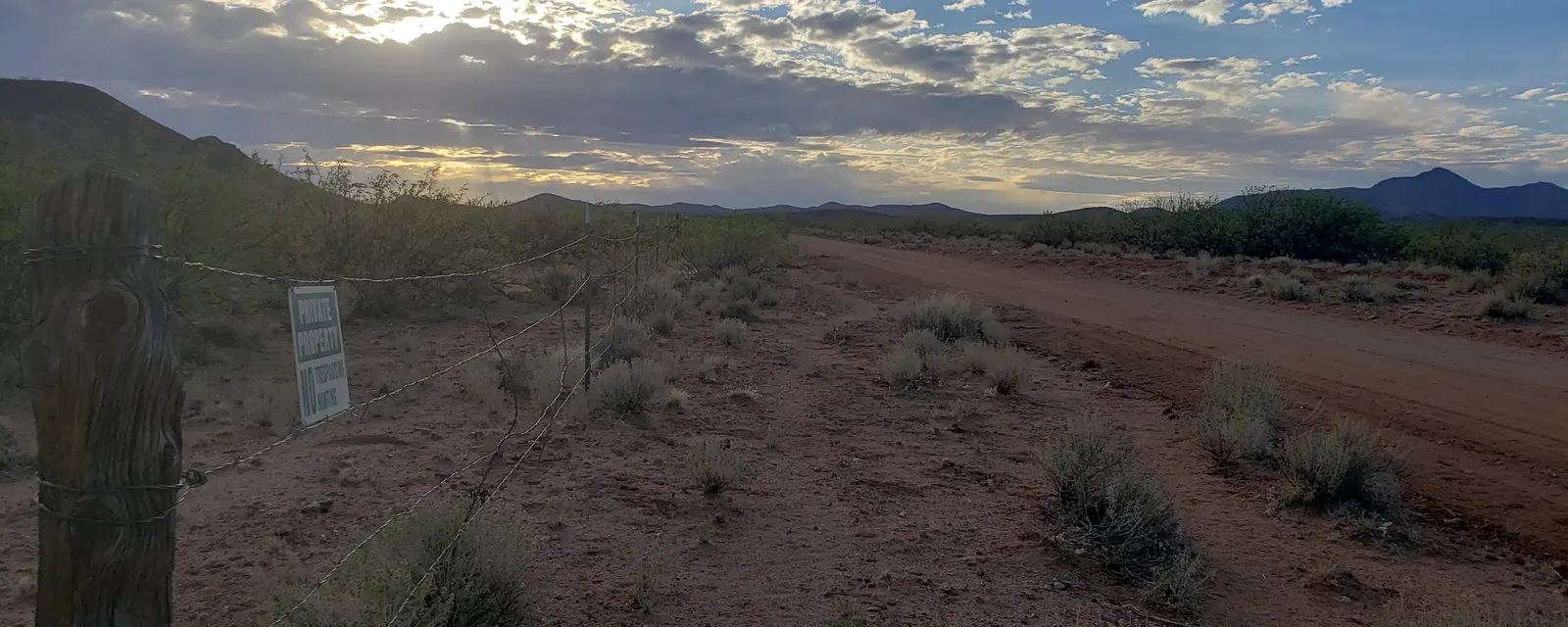 Sunset sky over a fence line and valley on the Arizona homestead
