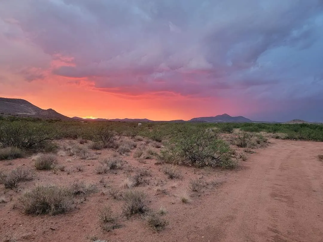 Desert sunset over the mountains near the WeVolution Off-Grid homestead outside Tombstone, Arizona