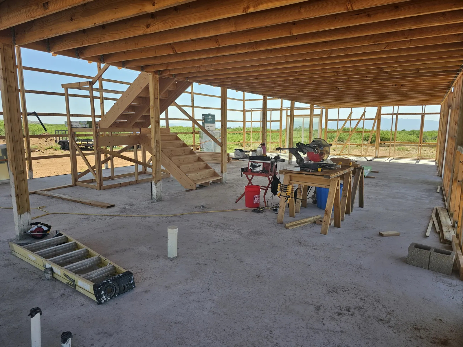 Open timber frame under a metal roof at our off-grid home build near Tombstone, Arizona