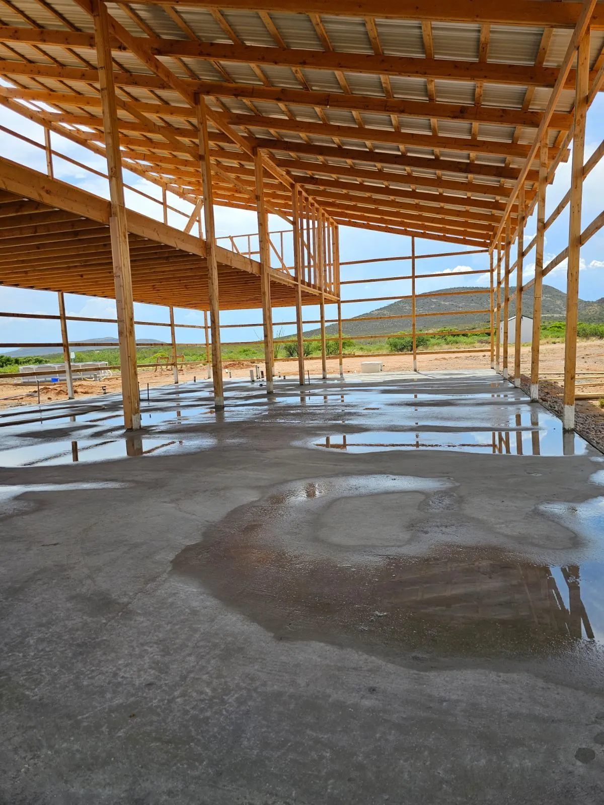 Roof framing going up over the concrete slab of our off-grid home near Tombstone, Arizona