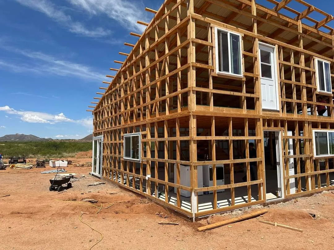 Timber frame of our off-grid home under construction on the homestead near Tombstone, Arizona