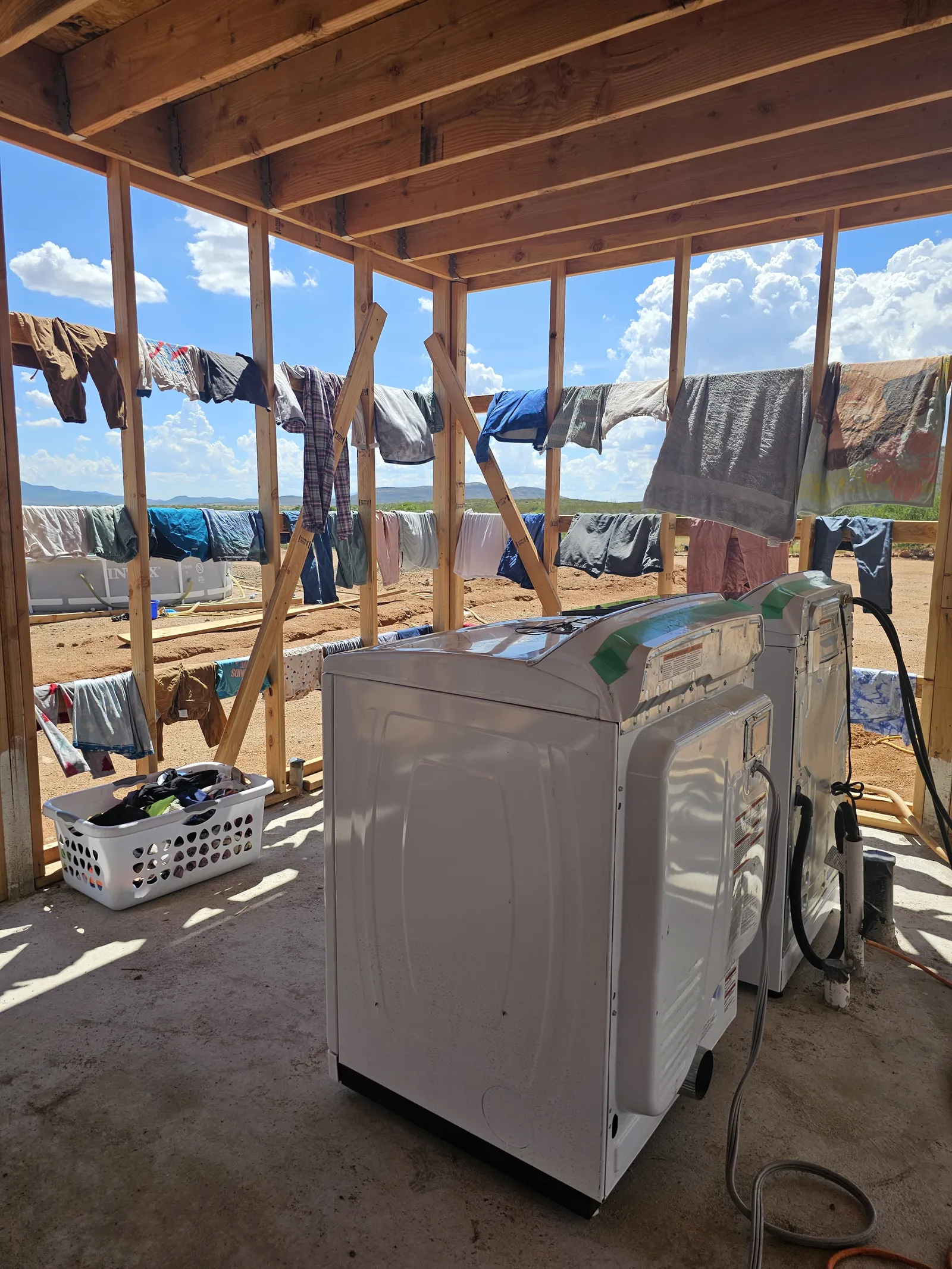 Washing machine and clothes drying on lines inside our off-grid build